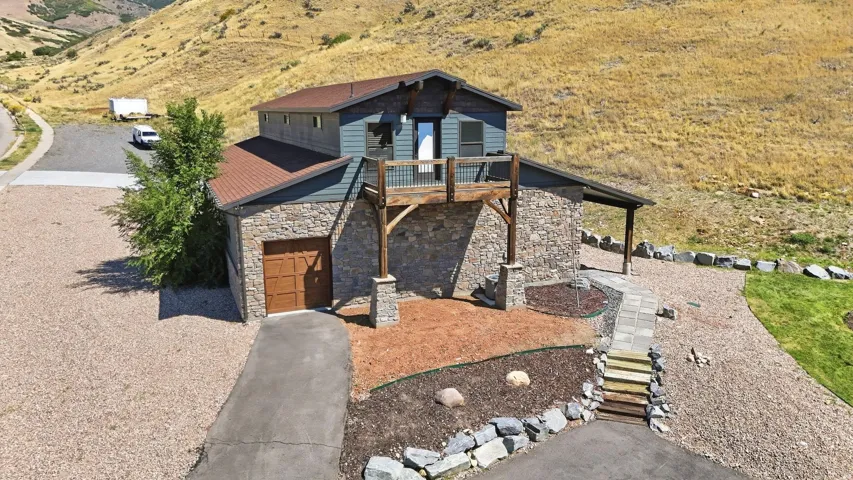 Stone and siding exterior with a pitched roof