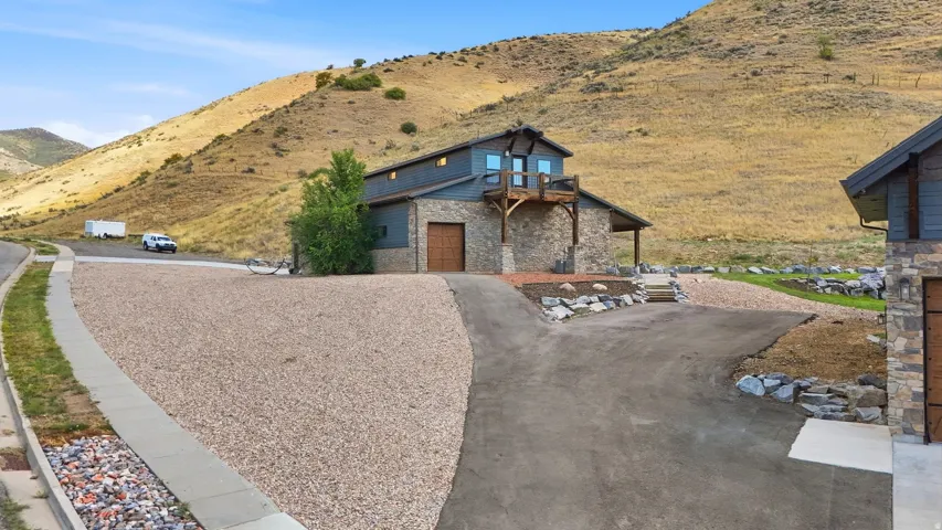 Stone and siding exterior with a wood-supported balcony
