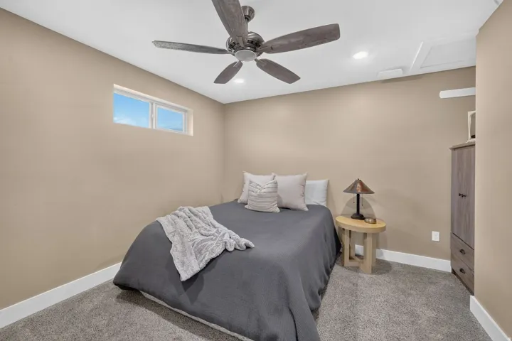 Recessed lighting, ceiling fan, high window, wall-to-wall carpeting, and neutral wall tones