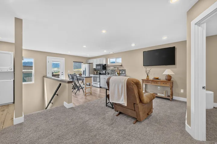 Open-concept living area with recessed lighting and neutral wall tones