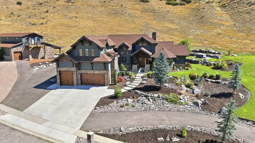 Craftsman-style residence with a multi-gabled roof and stone accents