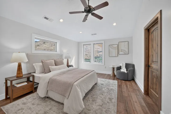 Recessed lighting, ceiling fan, wood-finish flooring, white trim, and a wood-panel door