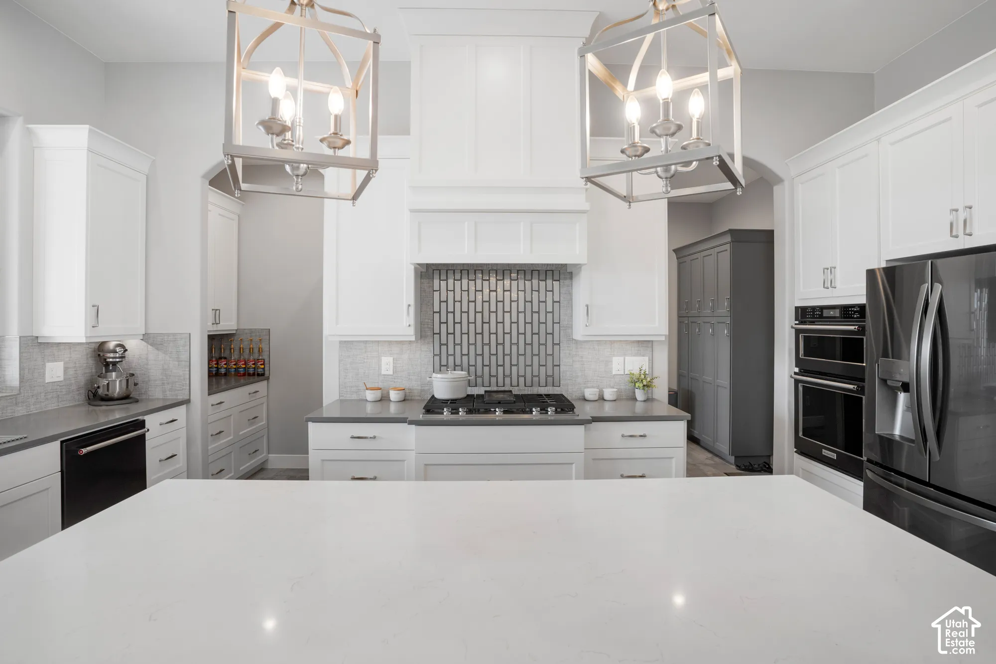 Kitchen featuring white cabinetry, a large kitchen island, stainless steel appliances, a tiled backsplash, and recessed lighting