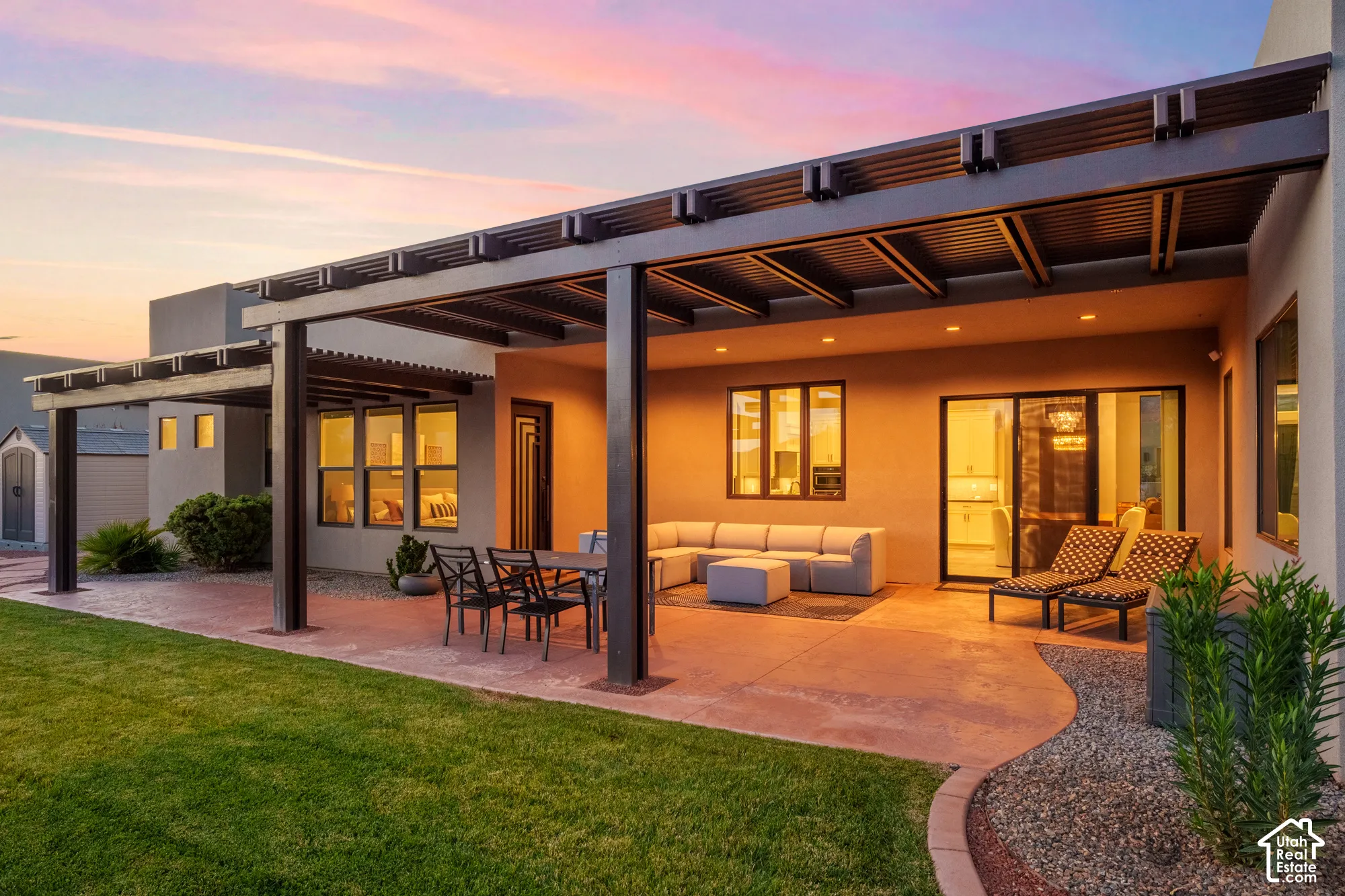 Expansive patio featuring a large pergola, recessed lighting, concrete flooring, and a sliding glass door