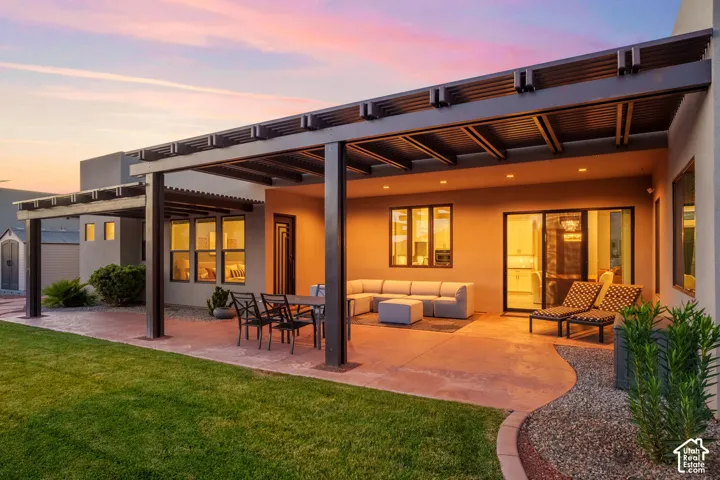 Expansive patio featuring a large pergola, recessed lighting, concrete flooring, and a sliding glass door