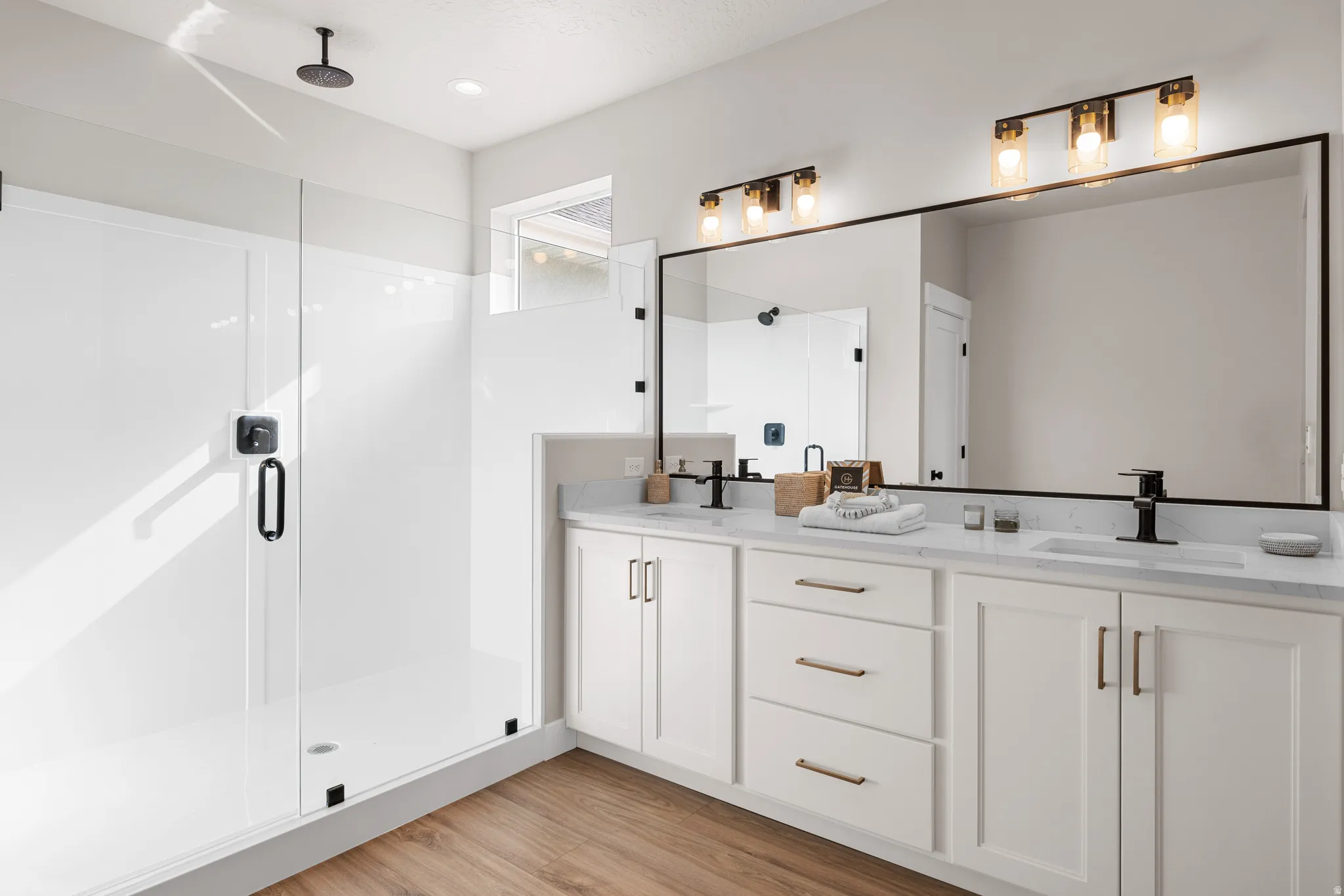 Dual vanity with white cabinetry and quartz countertops