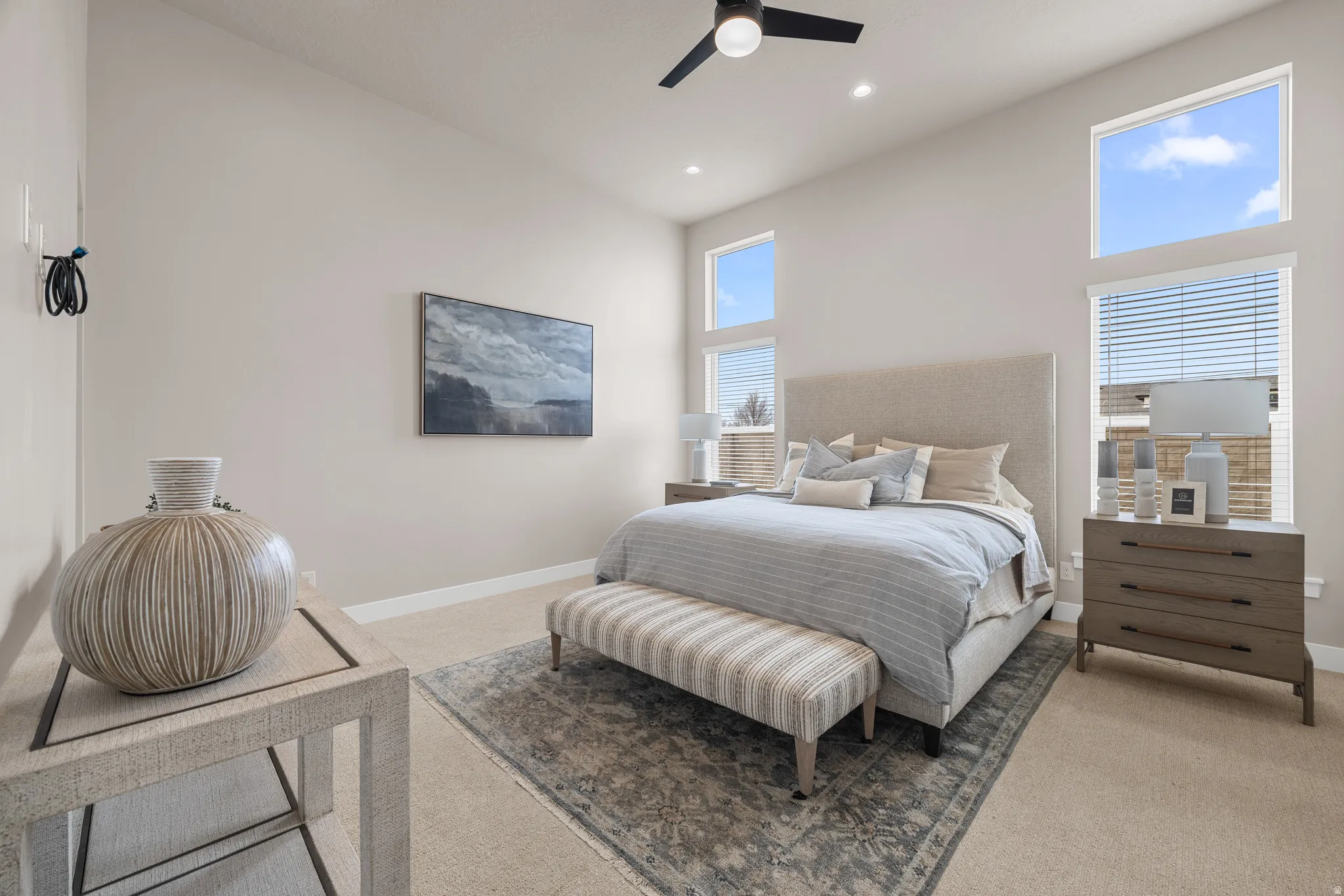 Vaulted ceilings with a ceiling fan, recessed lighting, and multiple windows with blinds