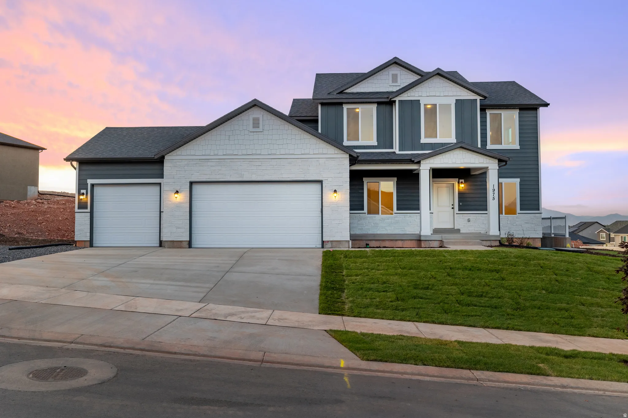 Contemporary two-story residence with a dual garage and a covered porch