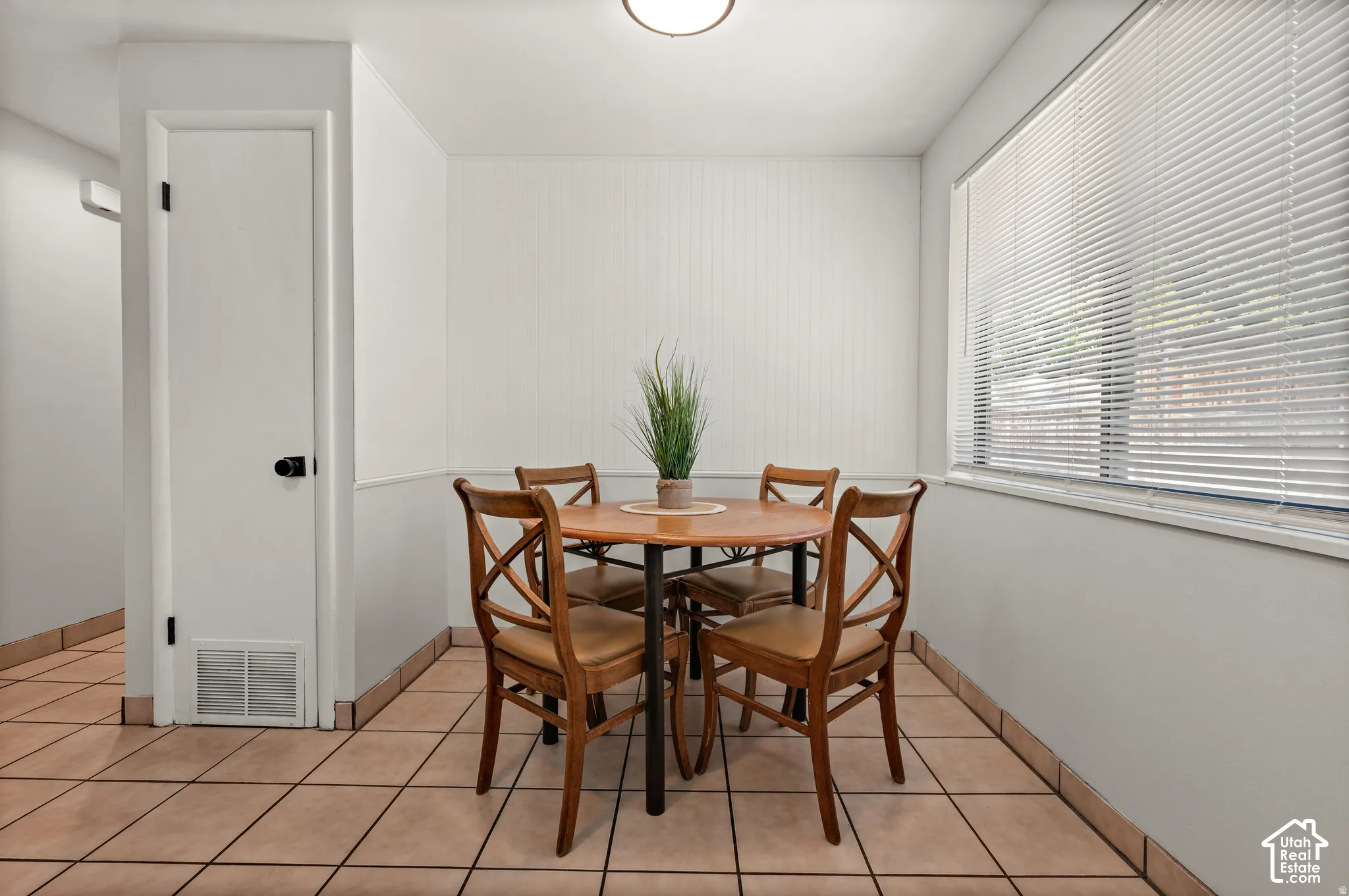 Recessed ceiling lighting, durable tile flooring, and a window with horizontal blinds