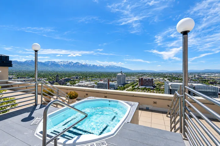 Rooftop terrace featuring a hot tub with beautiful mountain & city views