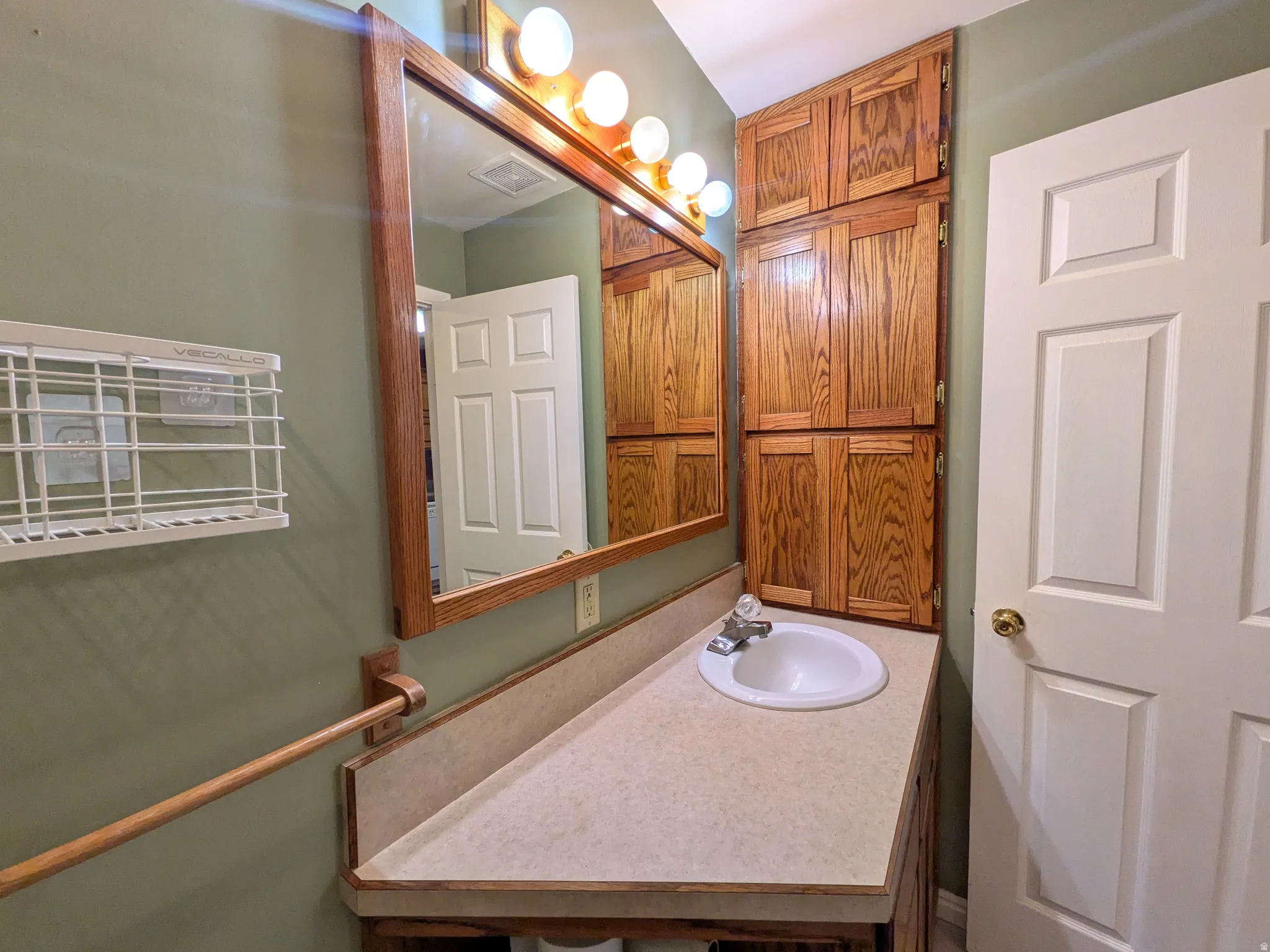 Wood-framed mirror with integrated vanity lighting