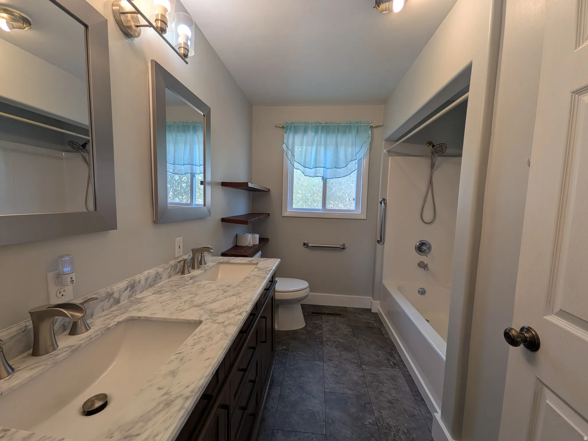 Dual vanity with integrated sinks and a marble-patterned countertop