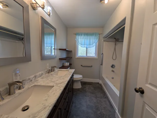 Dual vanity with integrated sinks and a marble-patterned countertop