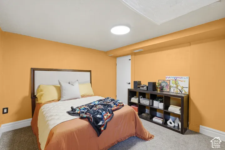 Bedroom #3 Recessed ceiling light, warm-toned wall paint, carpet flooring, and white trim work