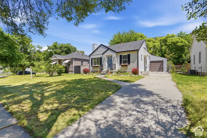 Traditional single-story residence with white siding, dark shutters, and a front porch