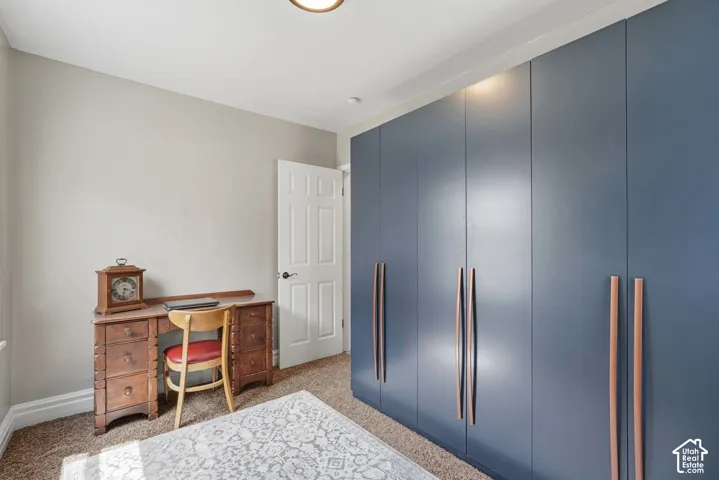 Bedroom #2 Built-in wardrobe with contemporary pulls, neutral wall tones, and carpet flooring. (built-ins can stay or be moved elsewhere)