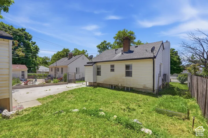 Expansive rear yard with a paved patio area