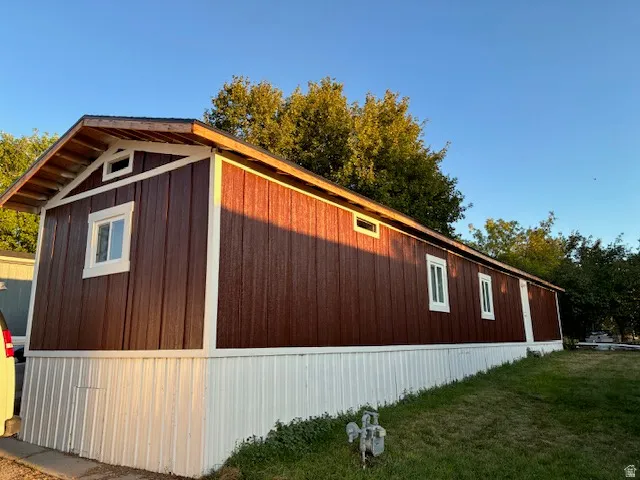 Brown vertical panel siding with white trim
