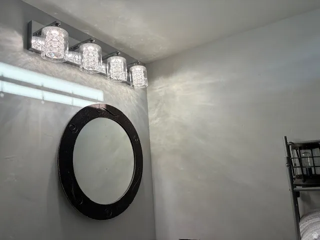 Four-light vanity fixture with crystal-style shades and polished chrome finish