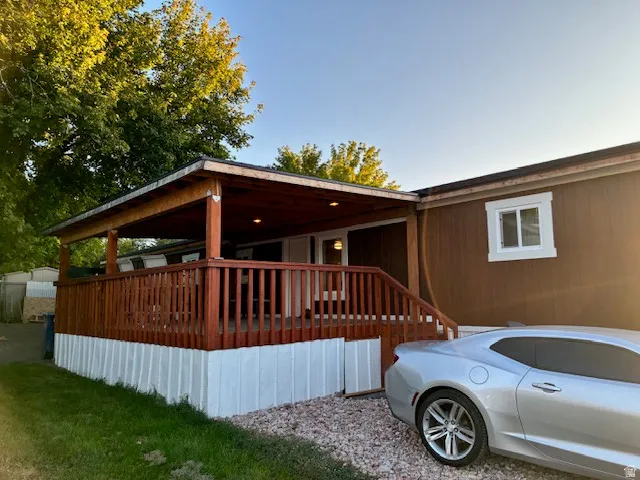 Expansive covered deck with wood railings and steps