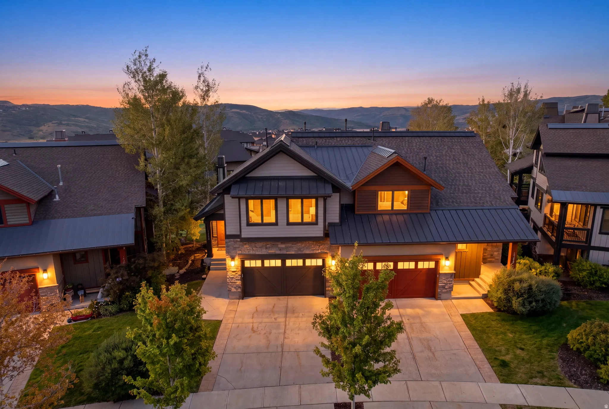 Stone and siding exterior with dark metal roofing