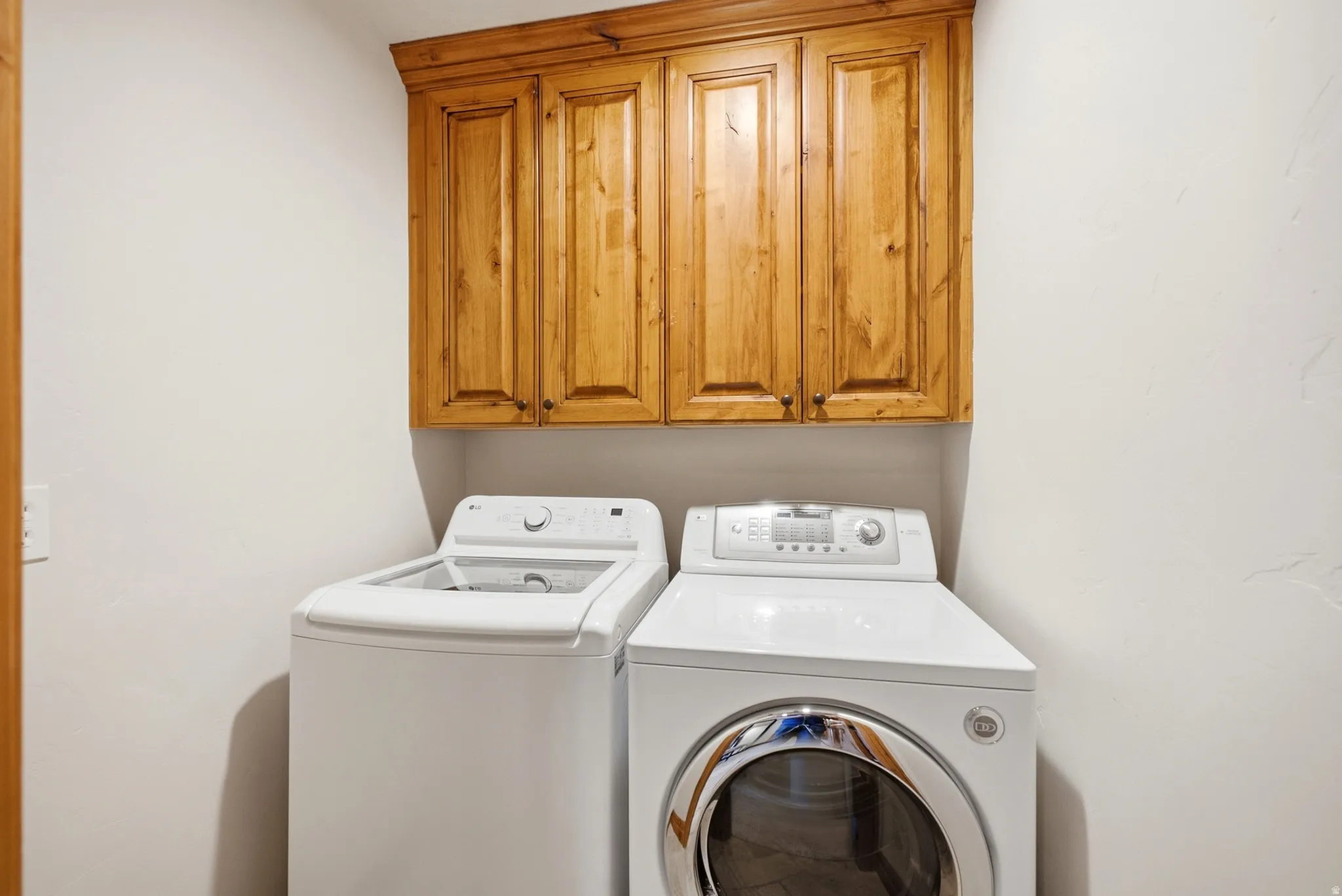 Wood-finish upper cabinetry provides storage