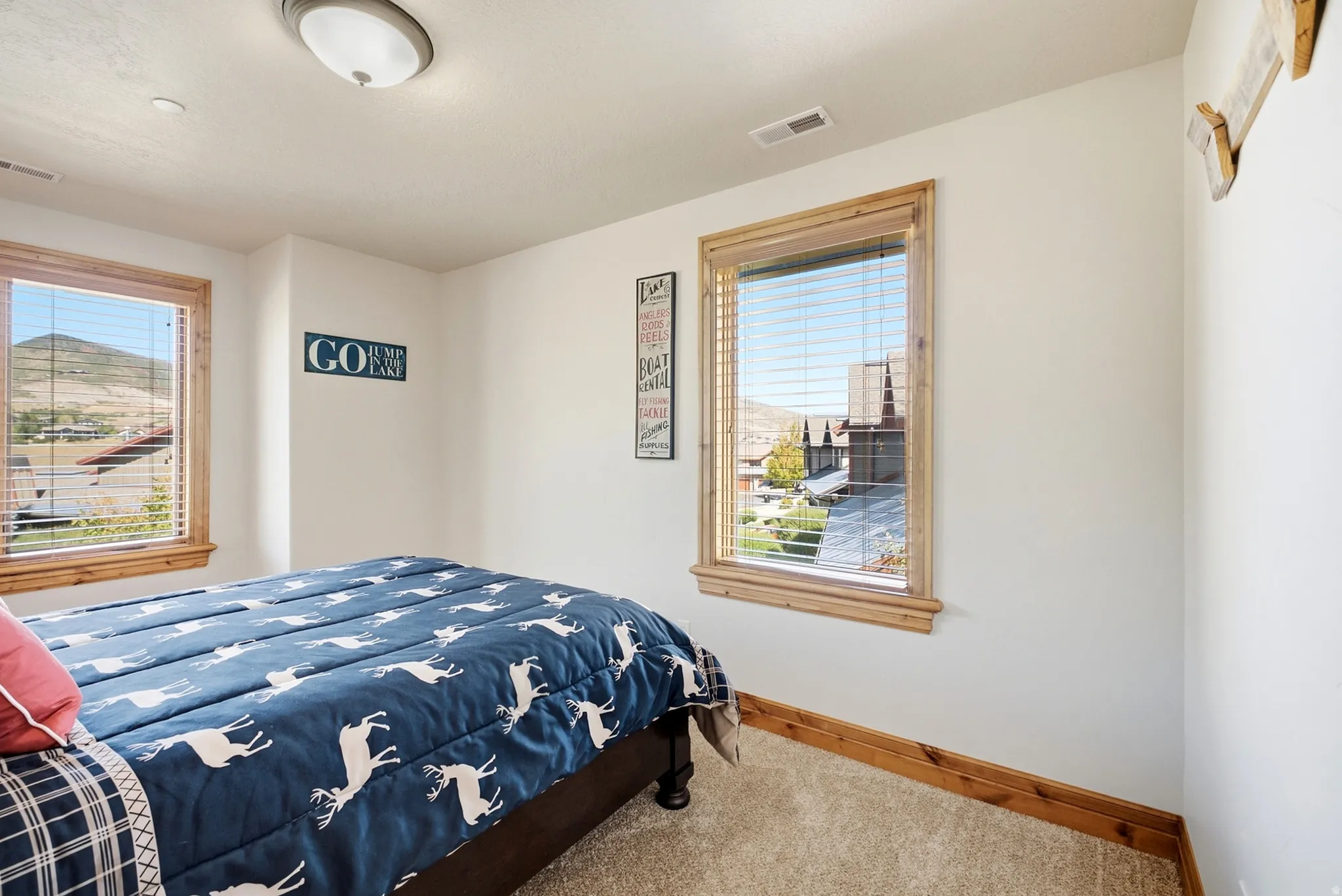 Windows featuring natural wood trim and blinds