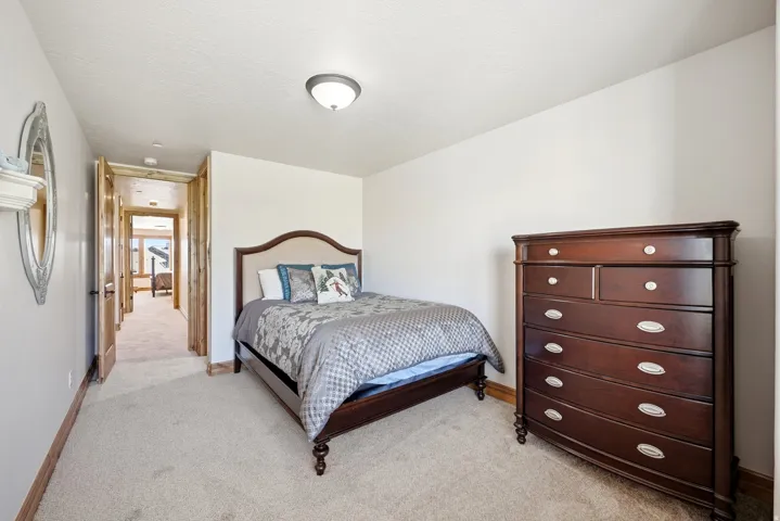 Carpeted flooring, white walls, and a flush mount ceiling light