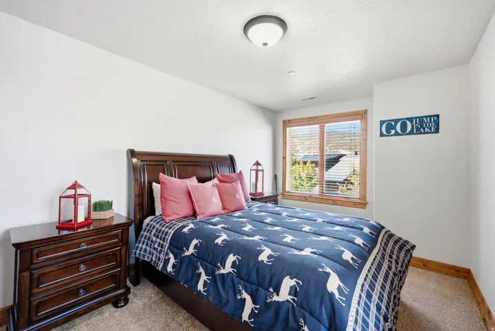 Recessed lighting, wood-trimmed window, and light-colored walls