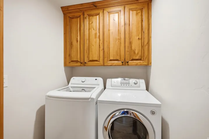 Wood-finish upper cabinetry provides storage