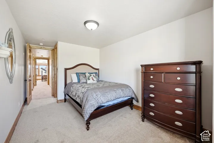 Carpeted flooring, white walls, and a flush mount ceiling light