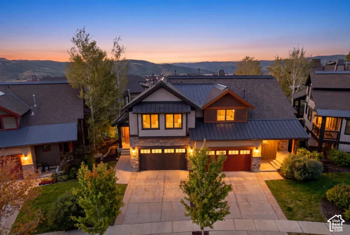 Stone and siding exterior with dark metal roofing