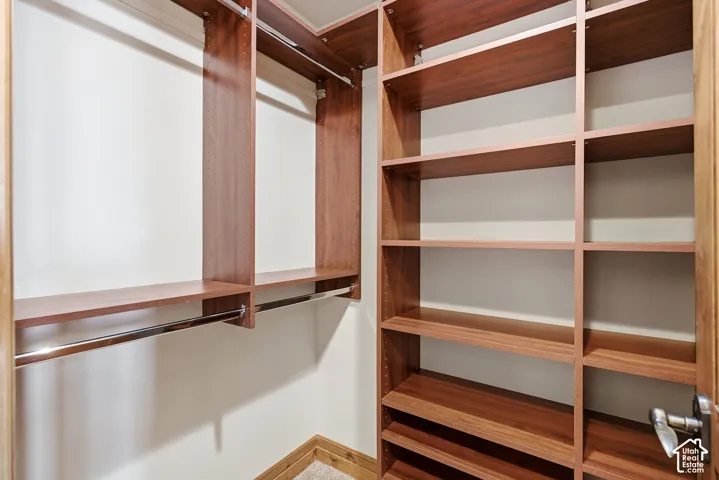Integrated wood-finish shelving, multiple hanging rods, and built-in closet organization