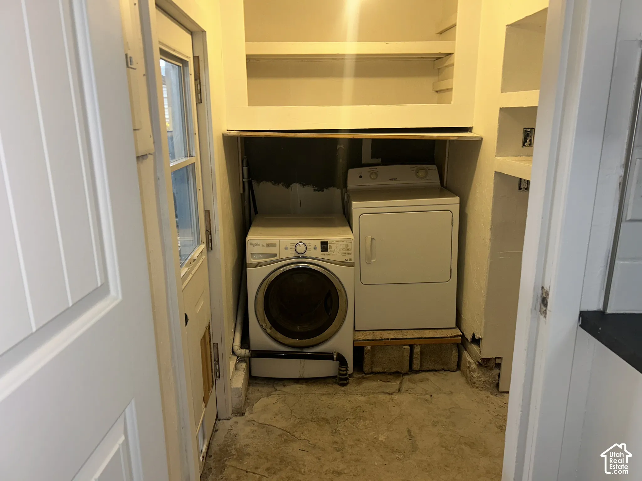 Dedicated laundry area featuring a front-load washer and dryer