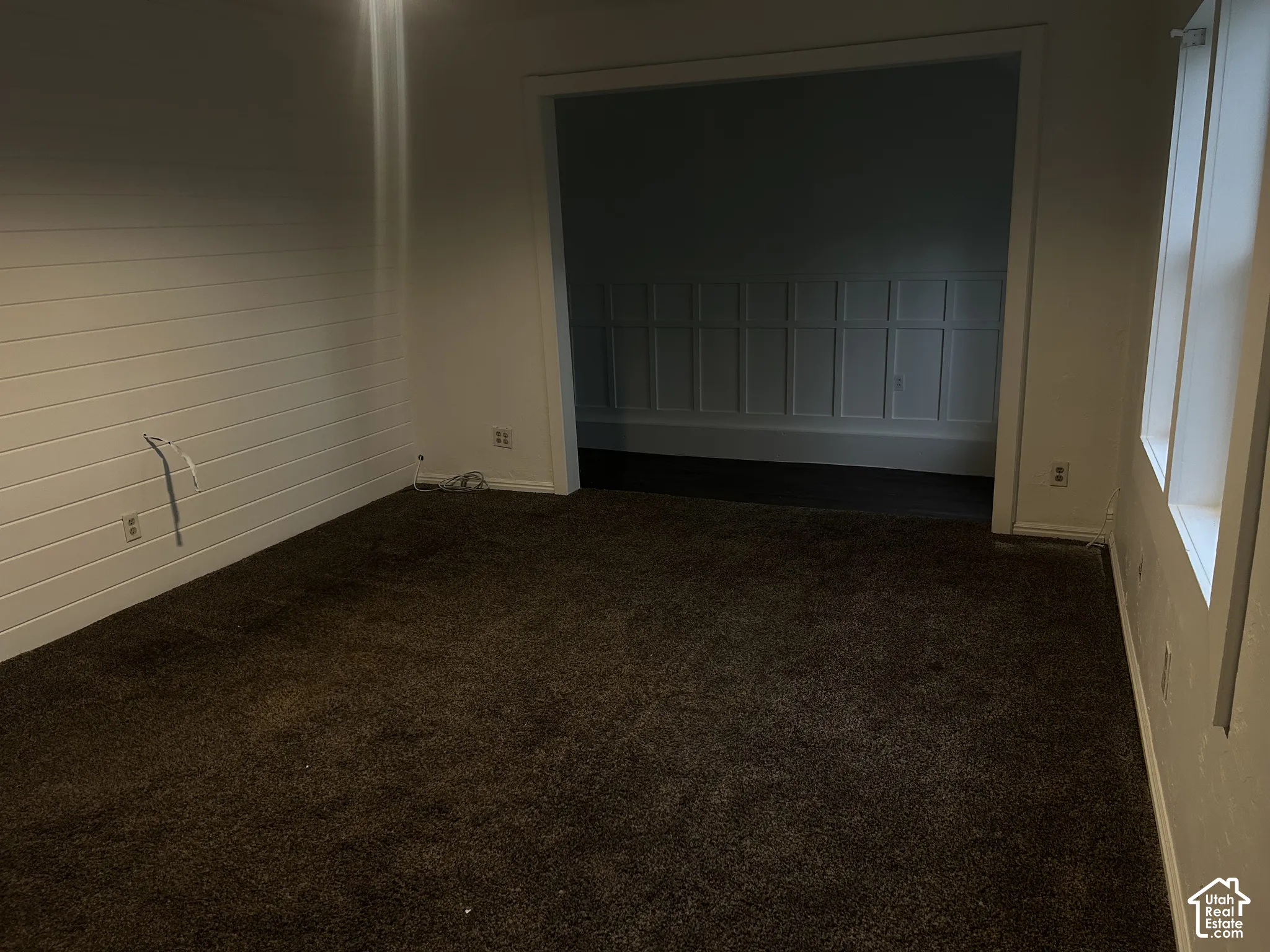 Carpeted flooring, ceiling fan with integrated lighting, white wall finishes, and wood-finish flooring