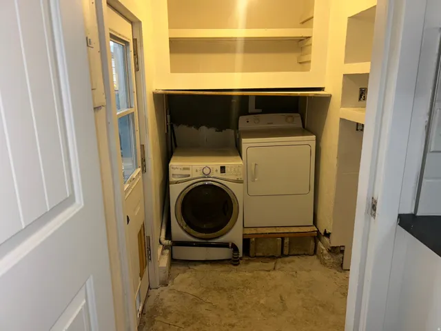 Dedicated laundry area featuring a front-load washer and dryer