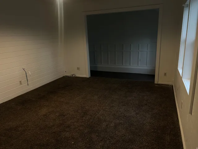 Carpeted flooring, ceiling fan with integrated lighting, white wall finishes, and wood-finish flooring