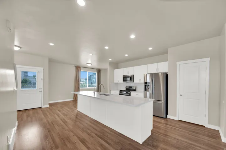 Open-concept living area featuring wood-finish flooring