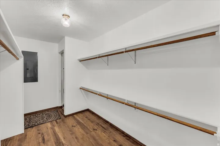 Wood-finish flooring with white walls and a surface-mounted ceiling light