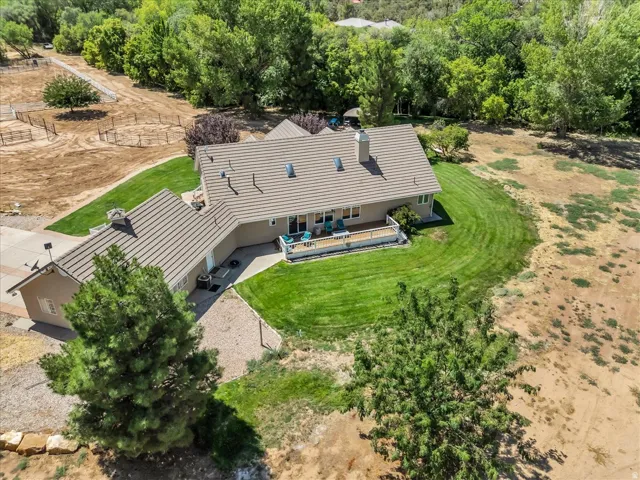 Single-story residence featuring a neutral exterior, tile roof, and an expansive rear deck