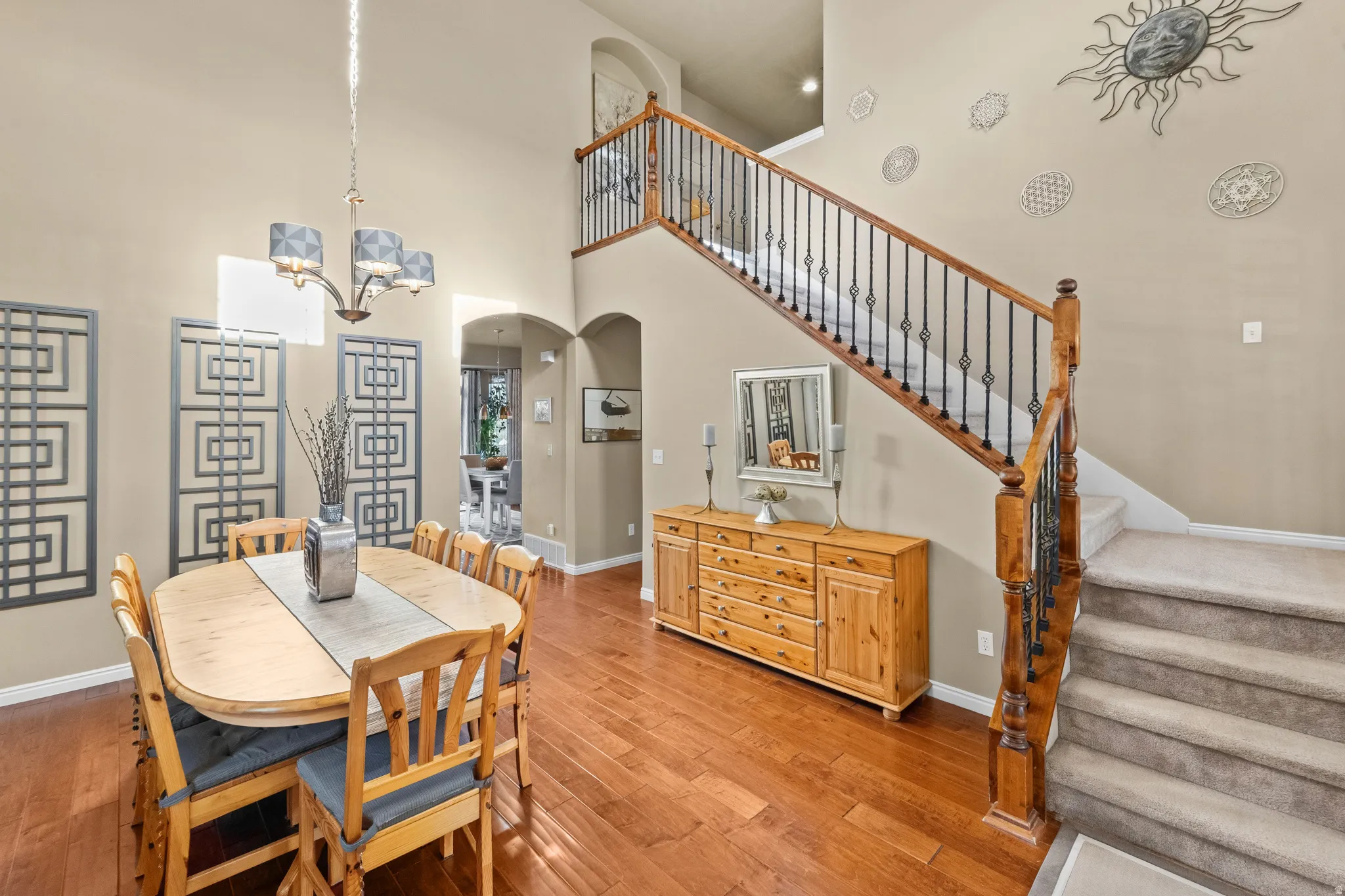 Welcome home, as you enter you are welcomed in with Vaulted ceilings, wood-finish flooring, wrought iron stair balusters, and arched doorways