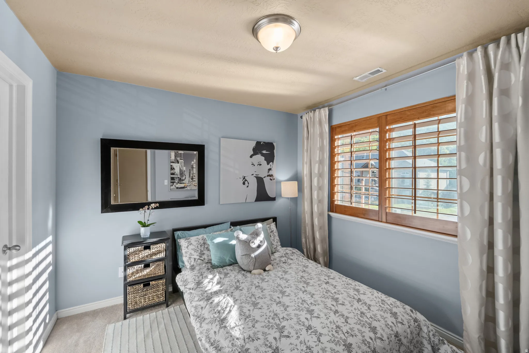 Bedroom 3  Window featuring wood shutters and curtain rods