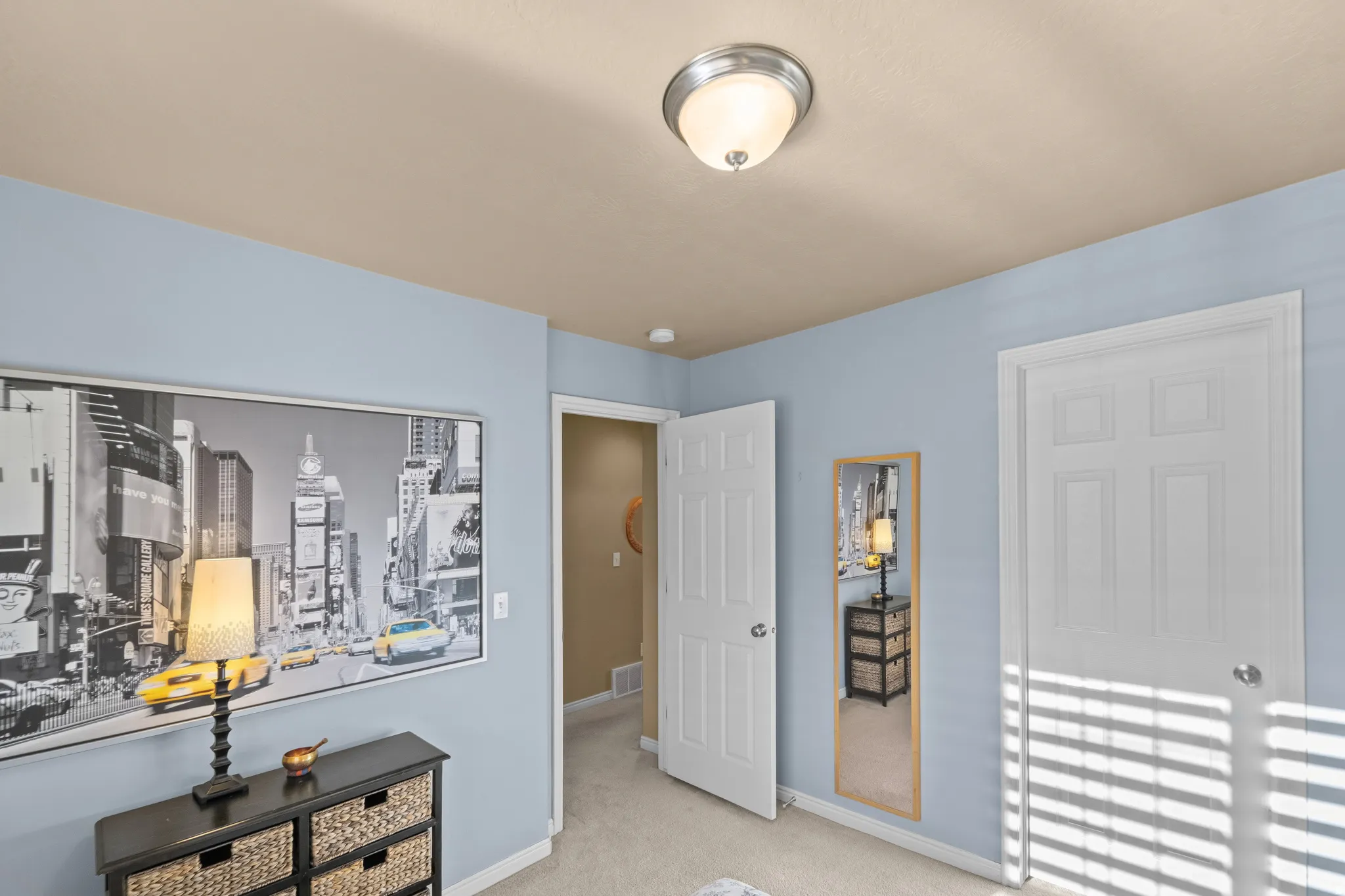 Bedroom 3 Ceiling-mounted semi-flush light fixture, light blue wall paint, and white paneled doors