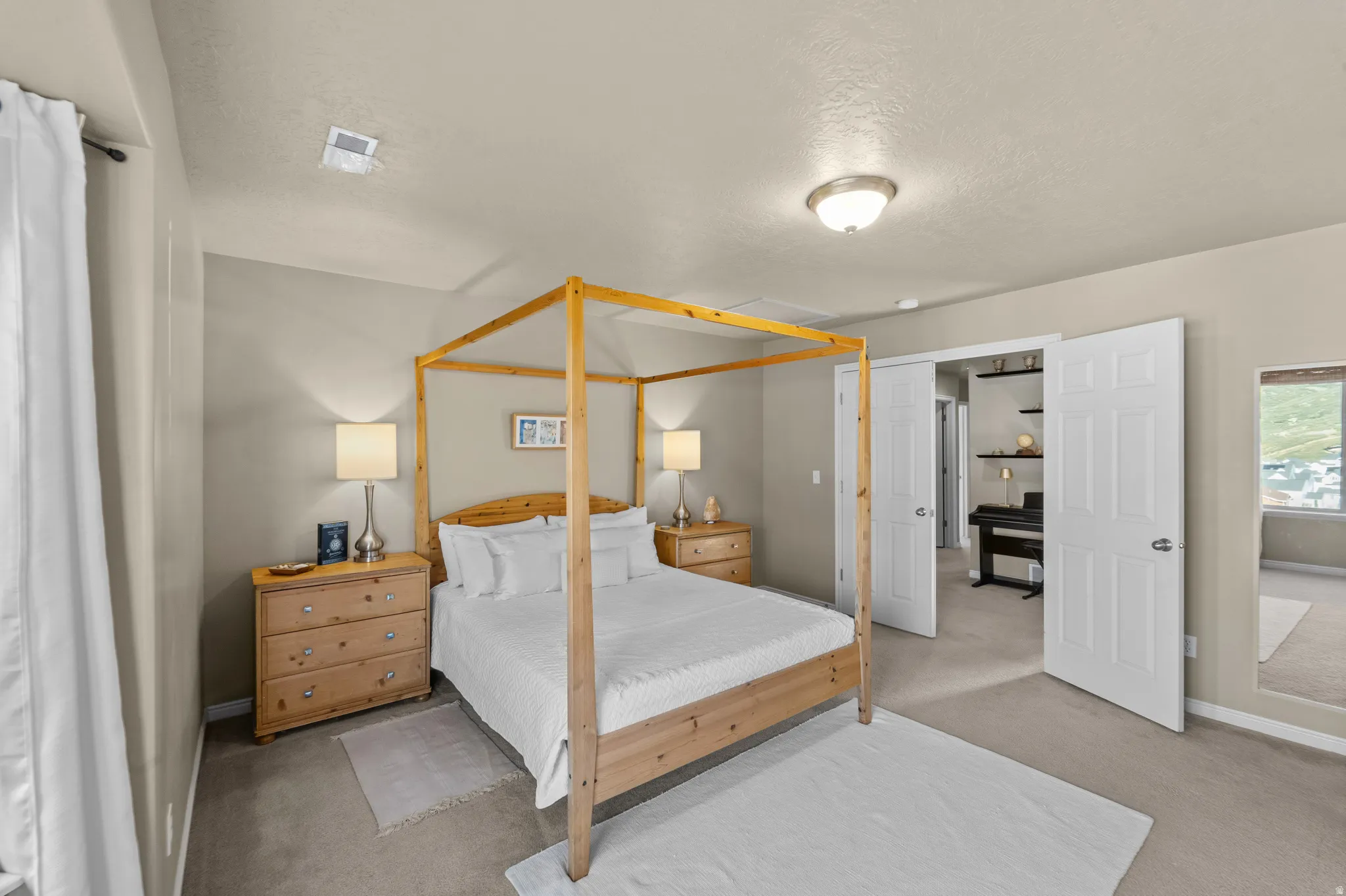 Master Suite Carpeted flooring with neutral wall tones and a ceiling-mounted light fixture