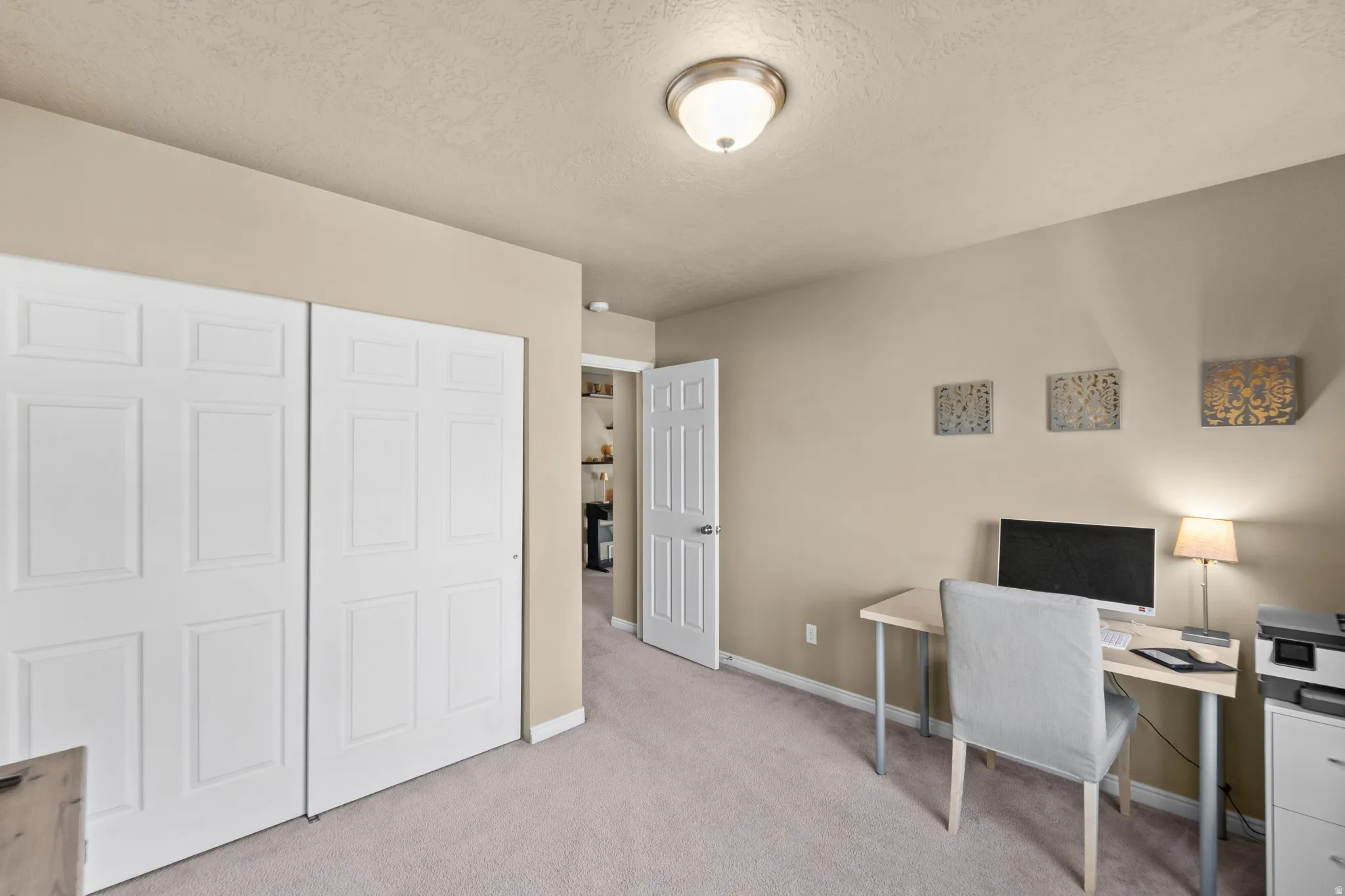 Bedroom 4 Neutral-toned walls, light carpeted flooring, white bi-fold closet doors, and an overhead flush-mount light fixture