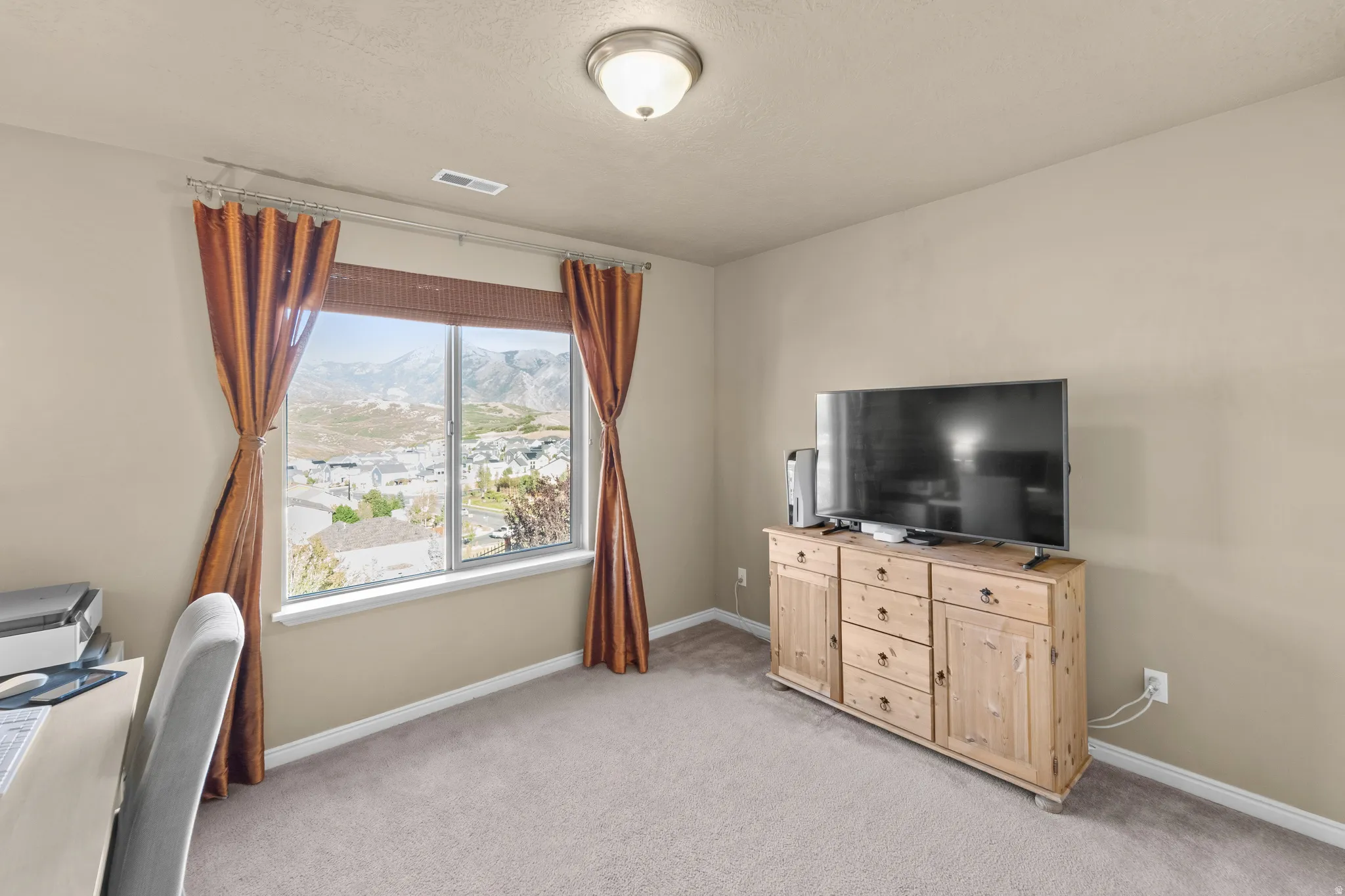 Bedroom 4 Neutral tone wall paint, flush mount ceiling light, carpeted flooring, and a large window with mountain scenery