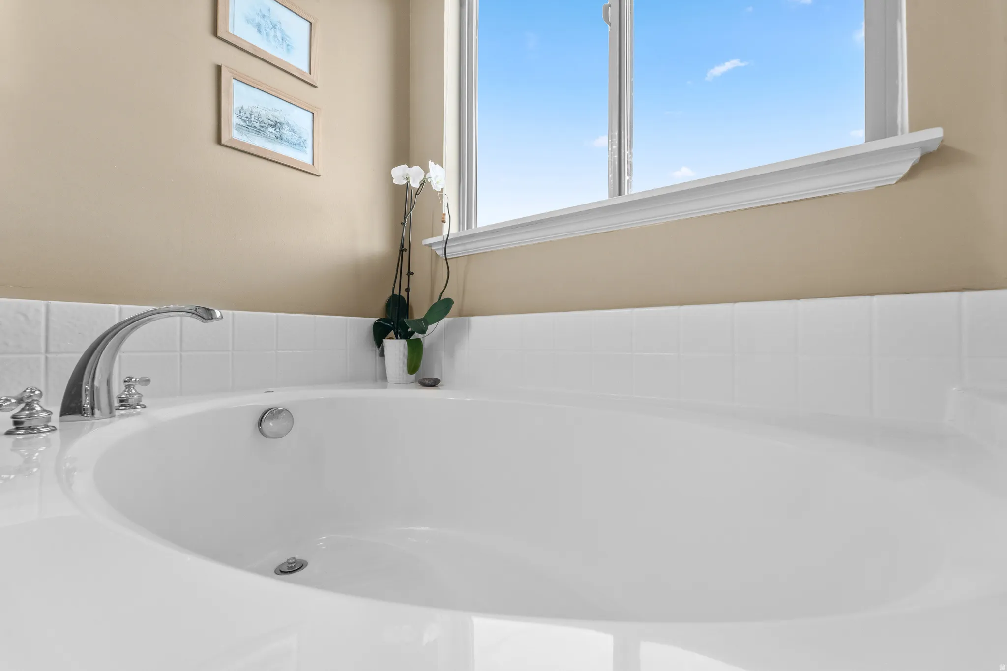 Master Suite Bathroom Built-in soaking tub with polished chrome fixtures and white subway tile surround