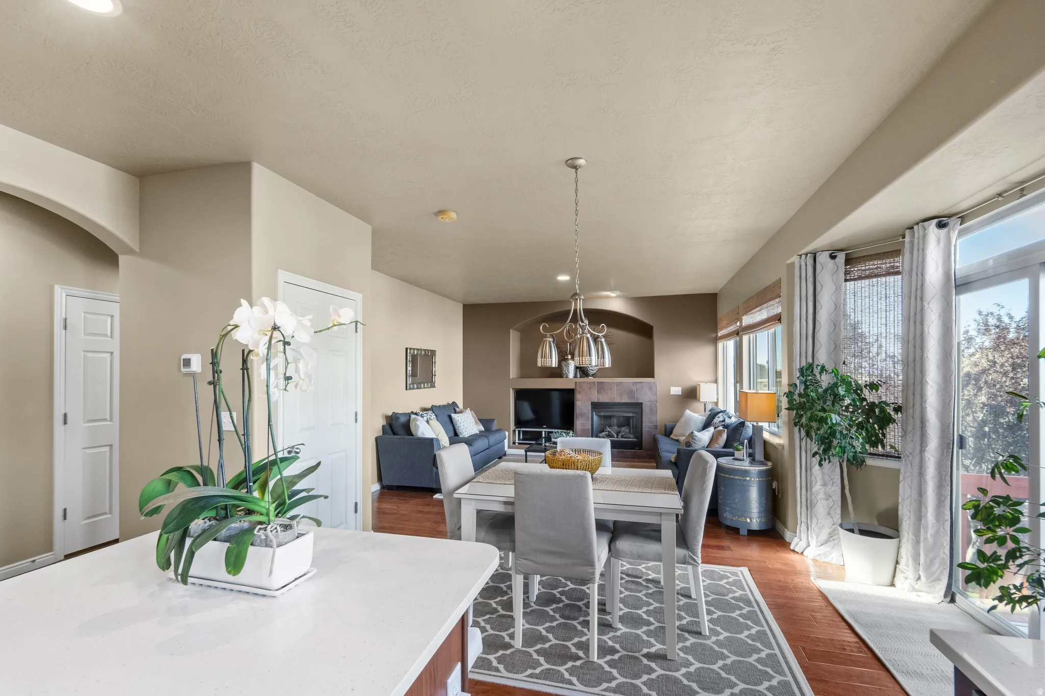 Open-concept living area featuring wood-finish flooring, a built-in fireplace, and expansive sliding glass doors