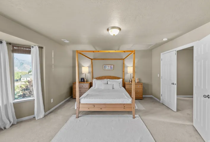 Master Suite - Carpeted flooring, neutral wall tones, window with mountain backdrop, and white paneled doors
