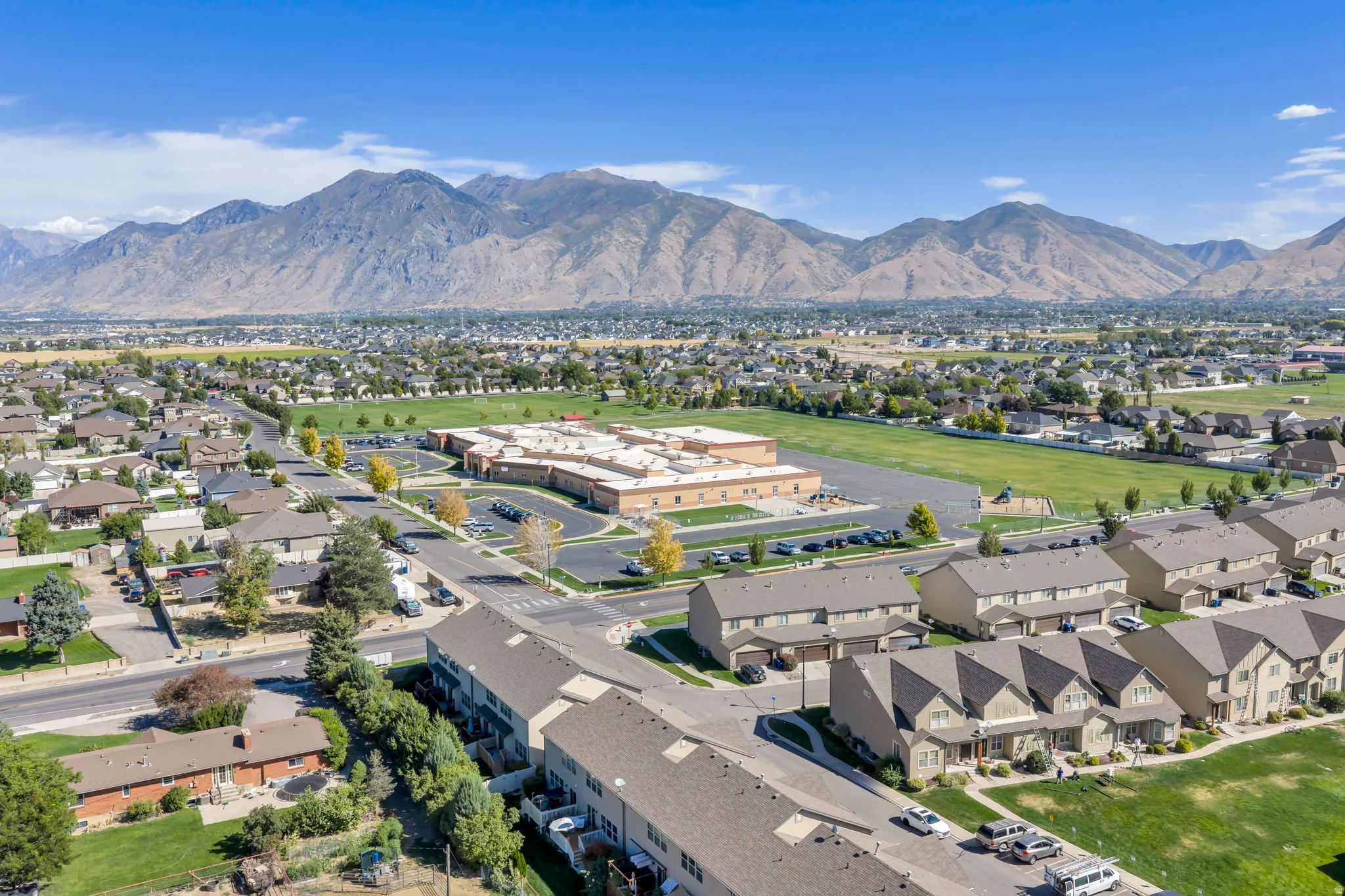 Expansive mountain backdrop with a residential community and green spaces